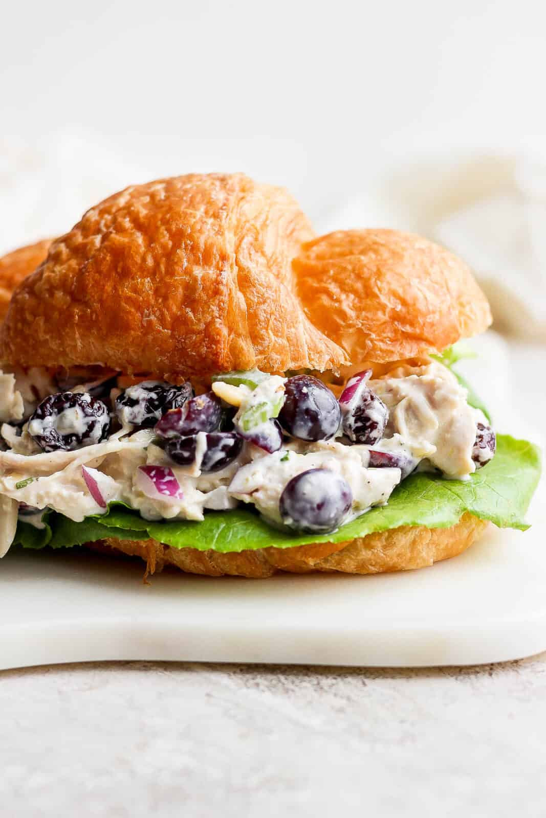 Smoked chicken salad on a croissant with lettuce. 