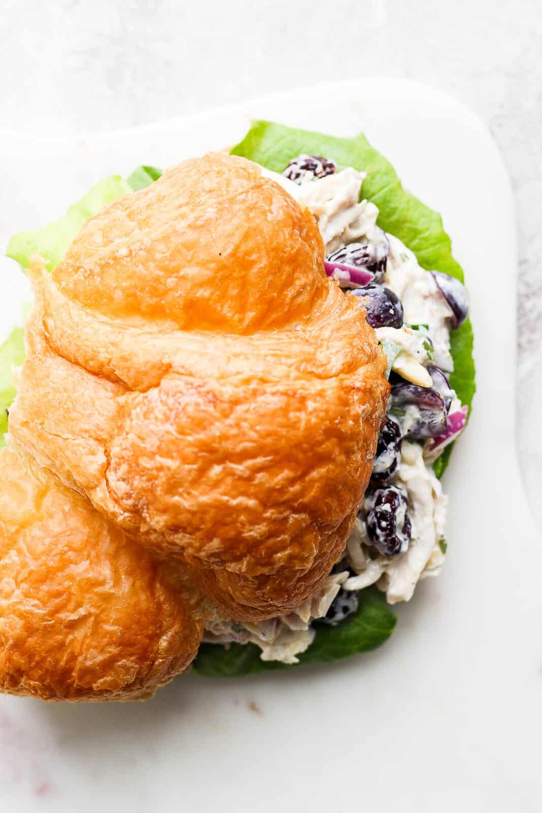 Smoked chicken salad on a croissant from the top view. 