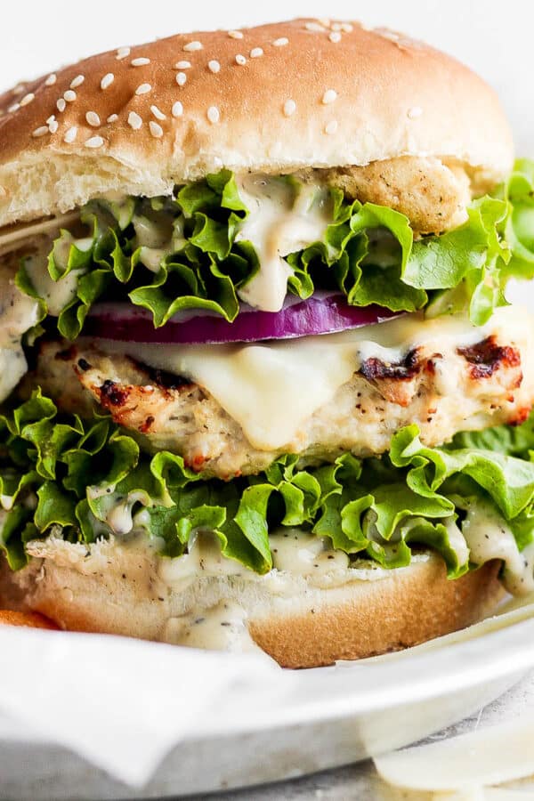 A chicken caesar burger on a plate.