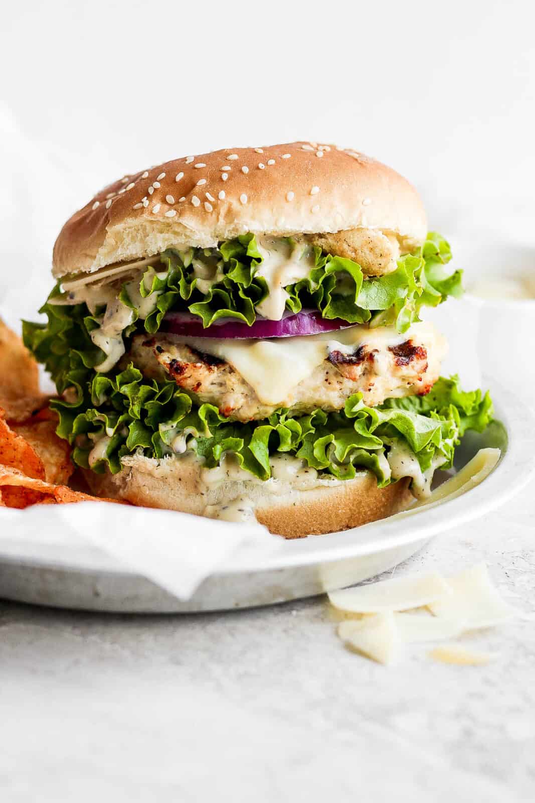 A chicken caesar burger on a plate.