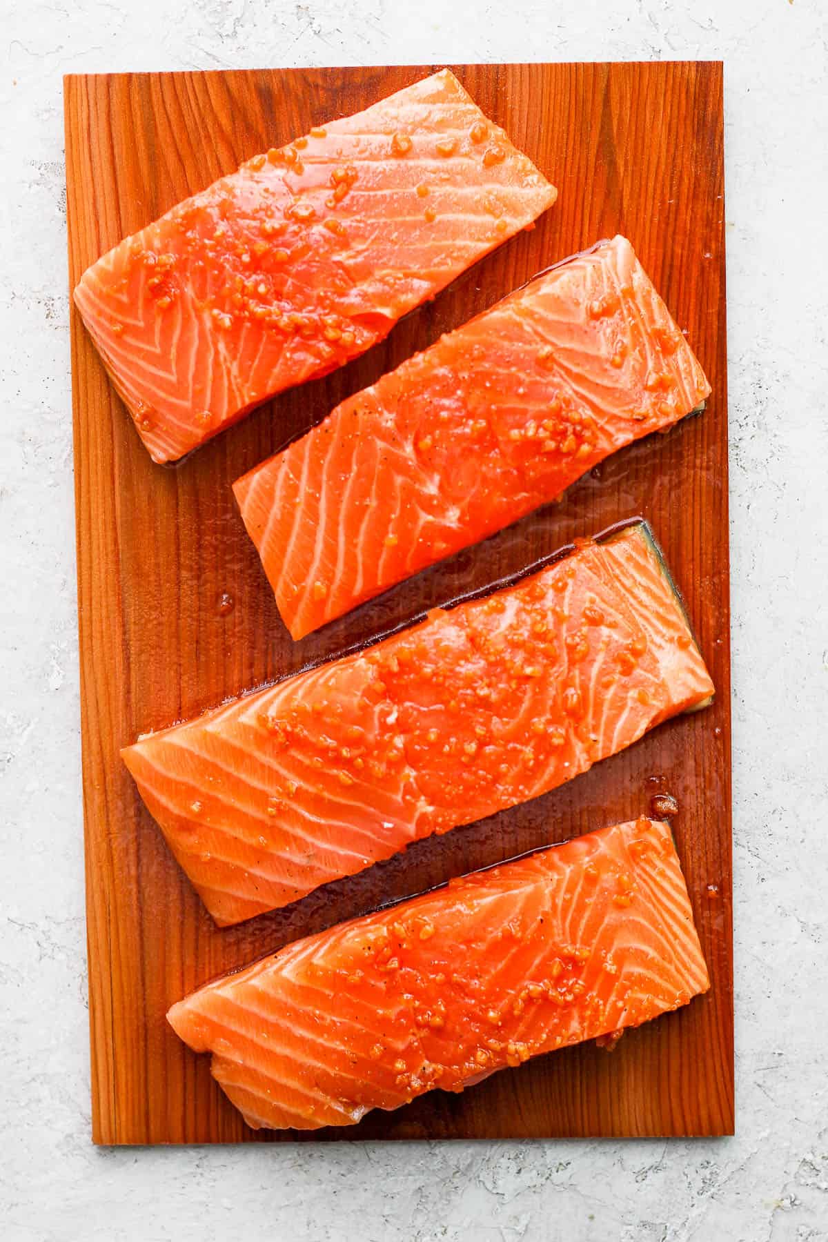 Marinated salmon on top of a cedar plank.