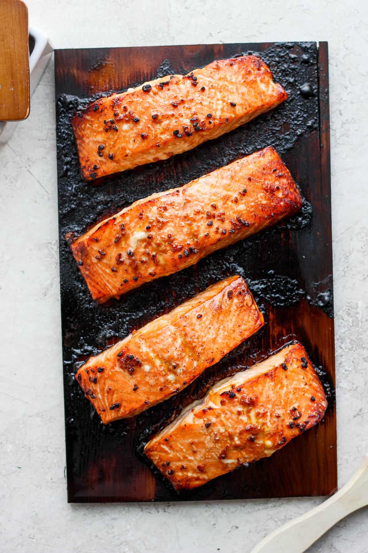 Cooked salmon on top of the cedar plank.