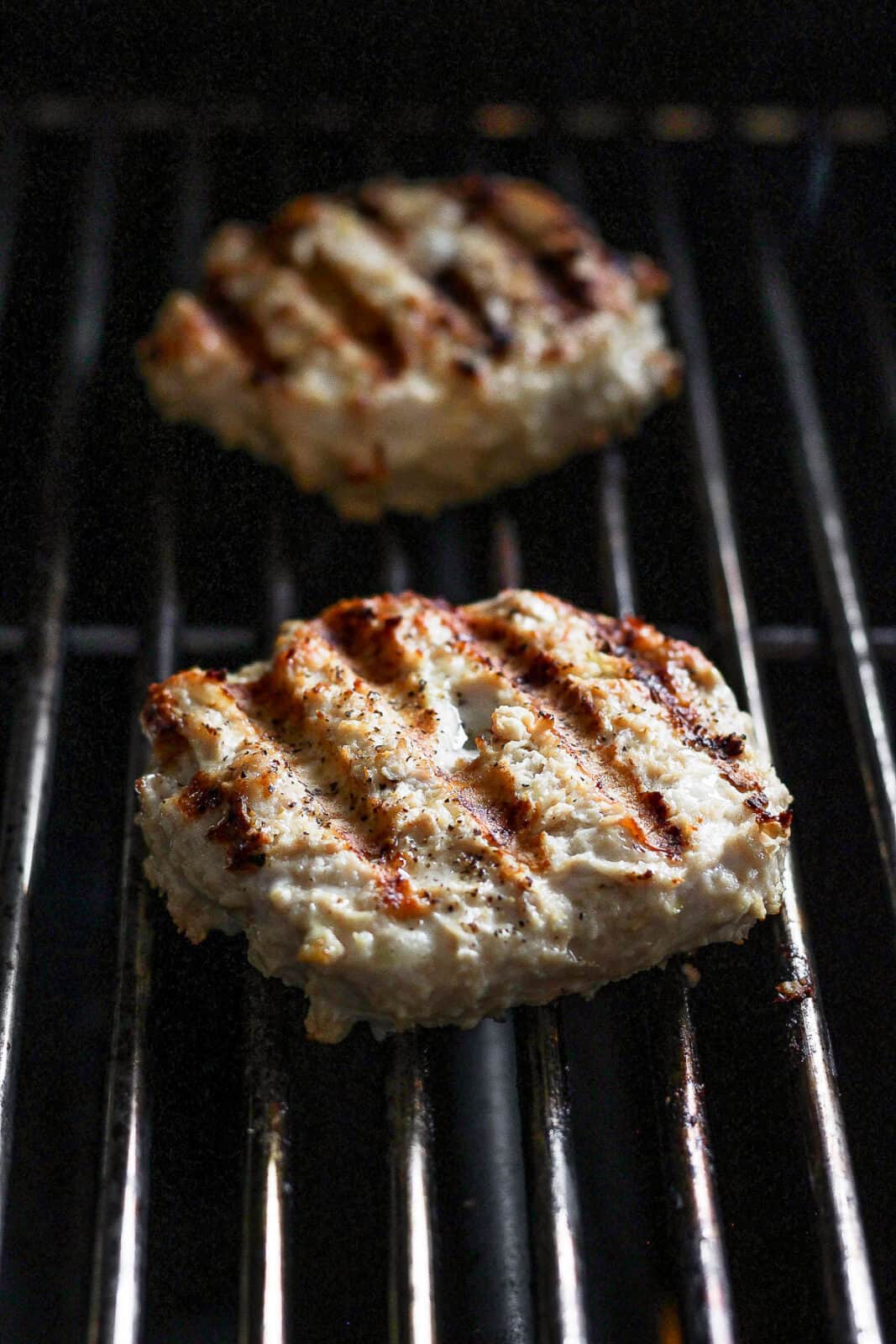 Chicken burgers on the grill.