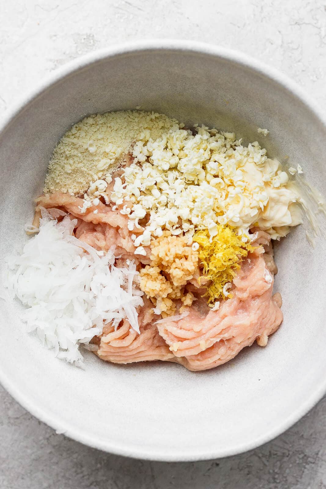 All the burger ingredients in a bowl.