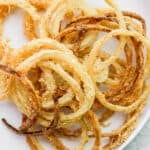 Plate of homemade fried onion strings.