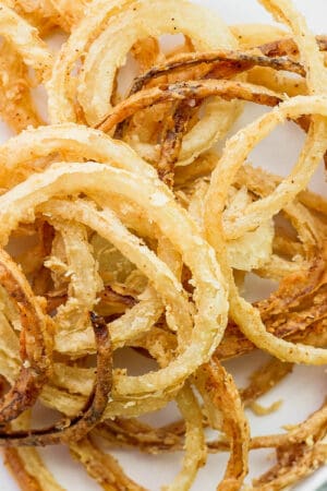 Plate of homemade fried onion strings.