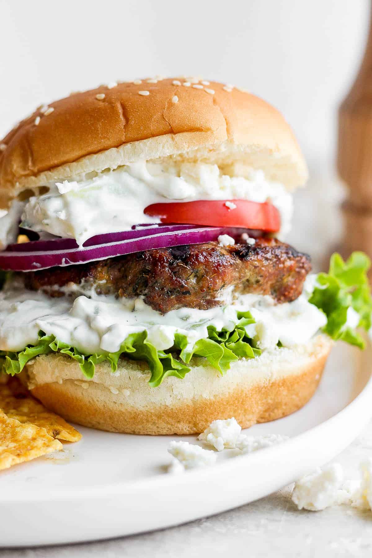 Lamb Burgers - a delicious, easy grilled lamb burger recipe topped with all the wonderful things like tzatziki, feta and tomato! #lambburgers #lambburgerswithtzatziki #lambburgerspatties #lambburgerswithfeta #lambburgersrecipe