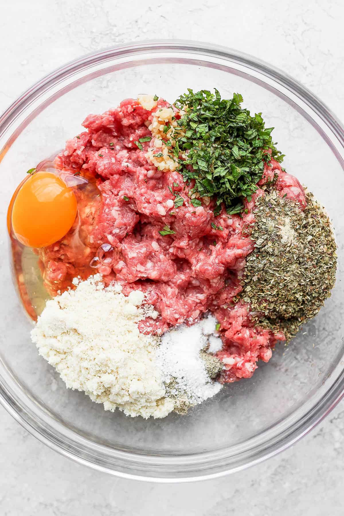 All the lamb burger ingredients in a mixing bowl.