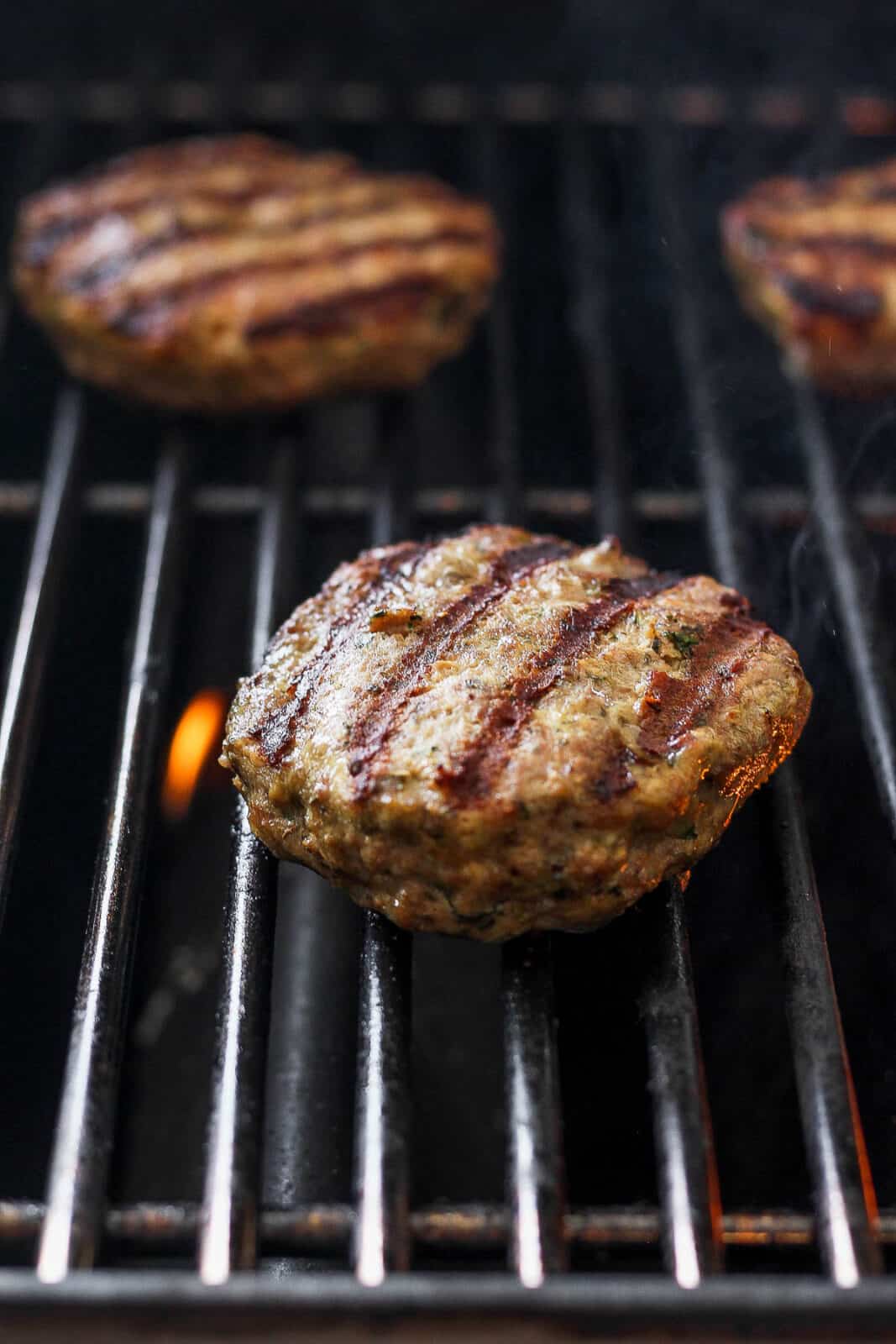 A lamb burger on the grill.