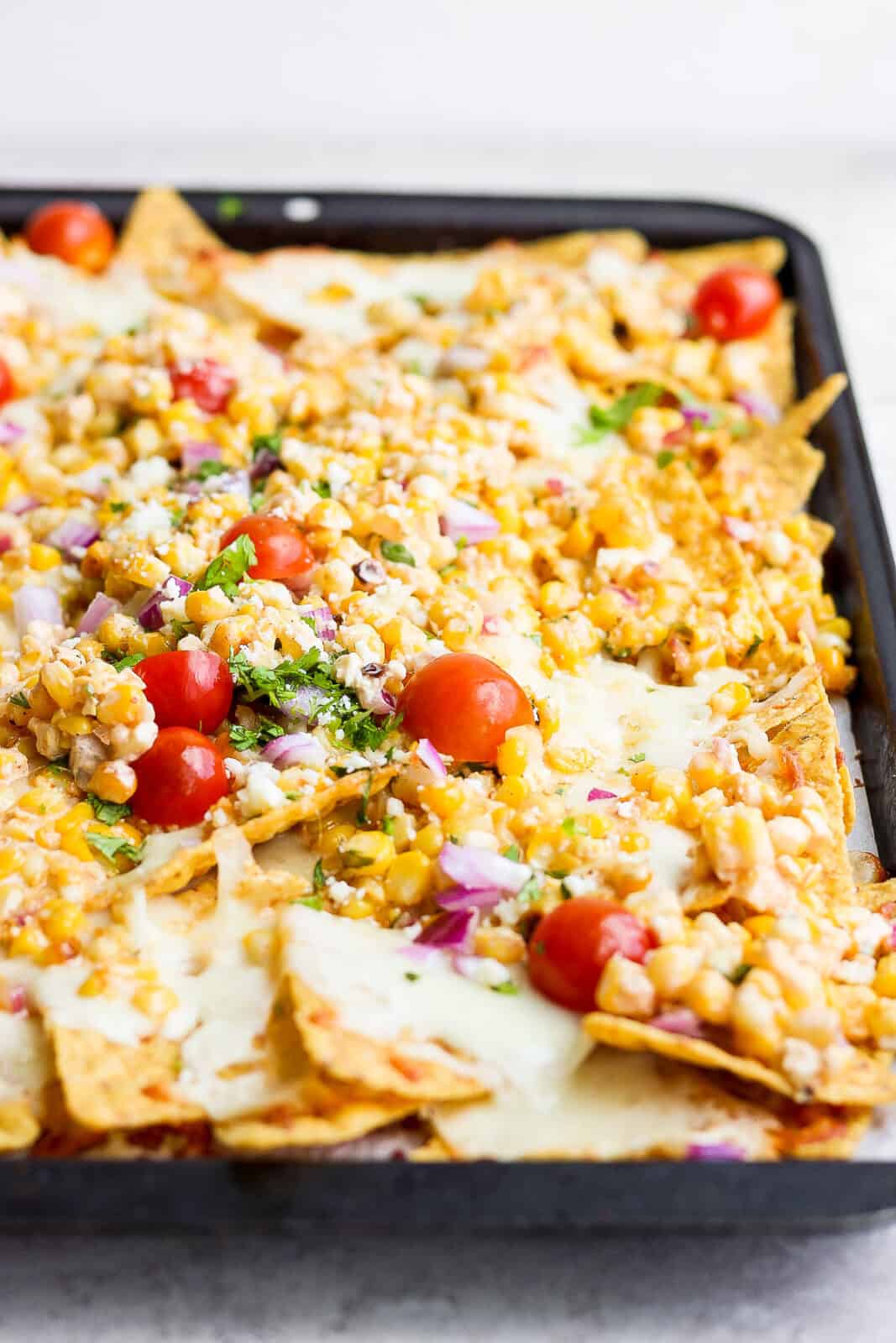 A sheet pan of Mexican street corn nachos.