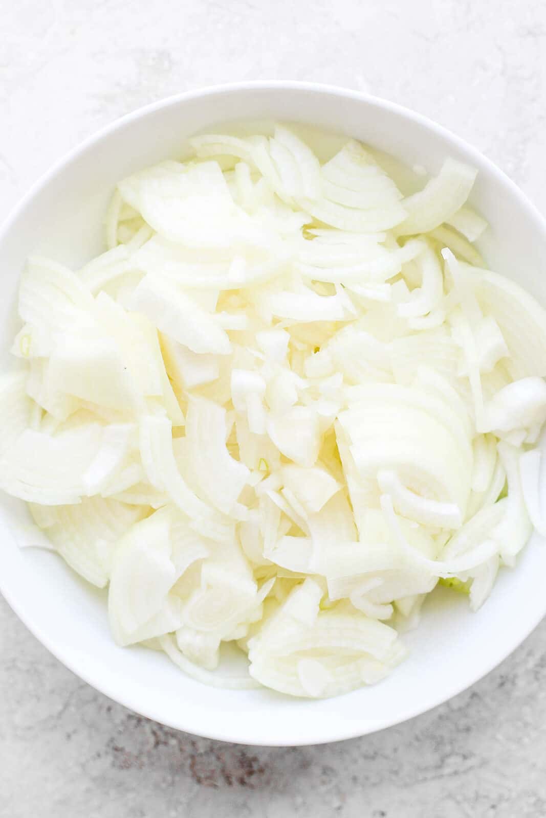 A large bowl of sliced onions.