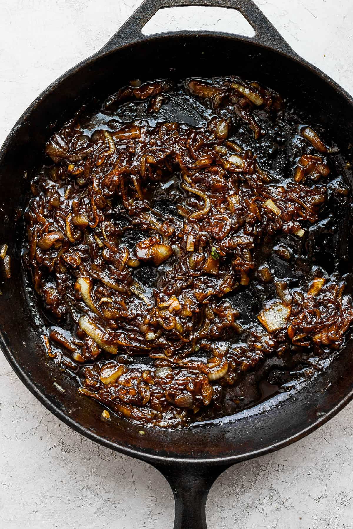 Thickened onion jam in a cast iron skillet.