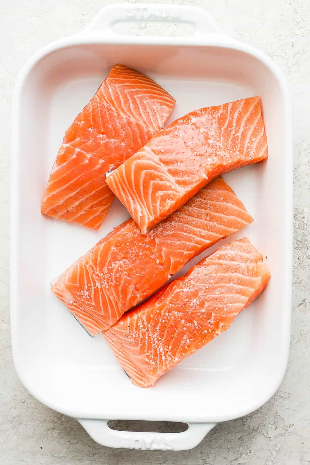 Salmon fillets in a baking dish.