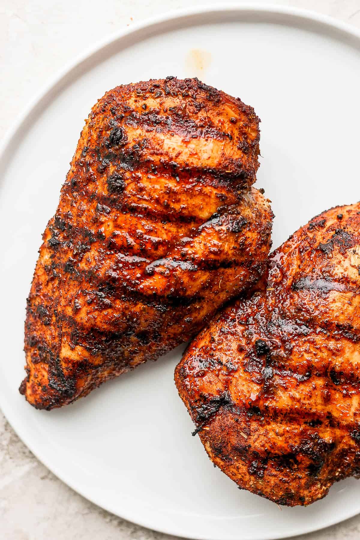 Seasoned chicken breasts after being grilled.