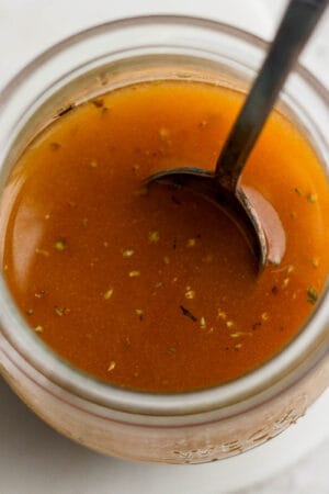 Jar of homemade southwest vinaigrette with a spoon sticking out of it.