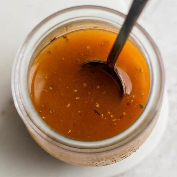 Jar of homemade southwest vinaigrette with a spoon sticking out of it.