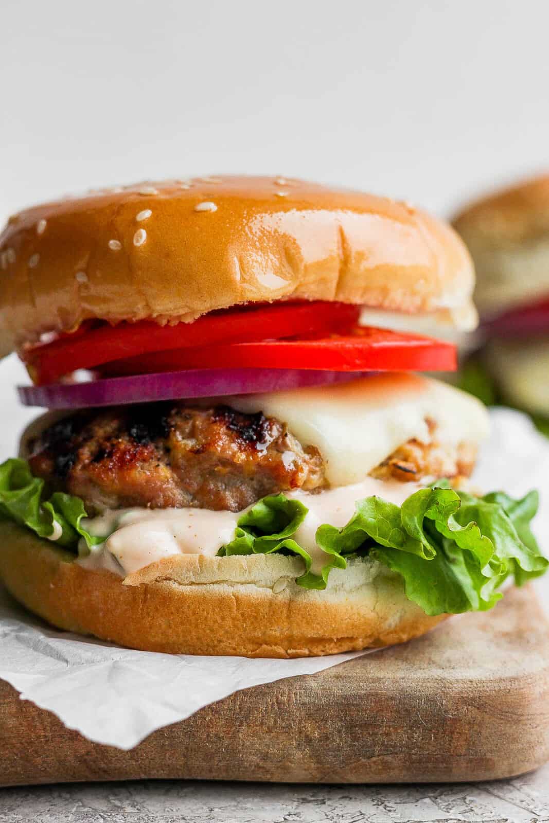 A juicy grilled turkey burger on a bun with toppings.