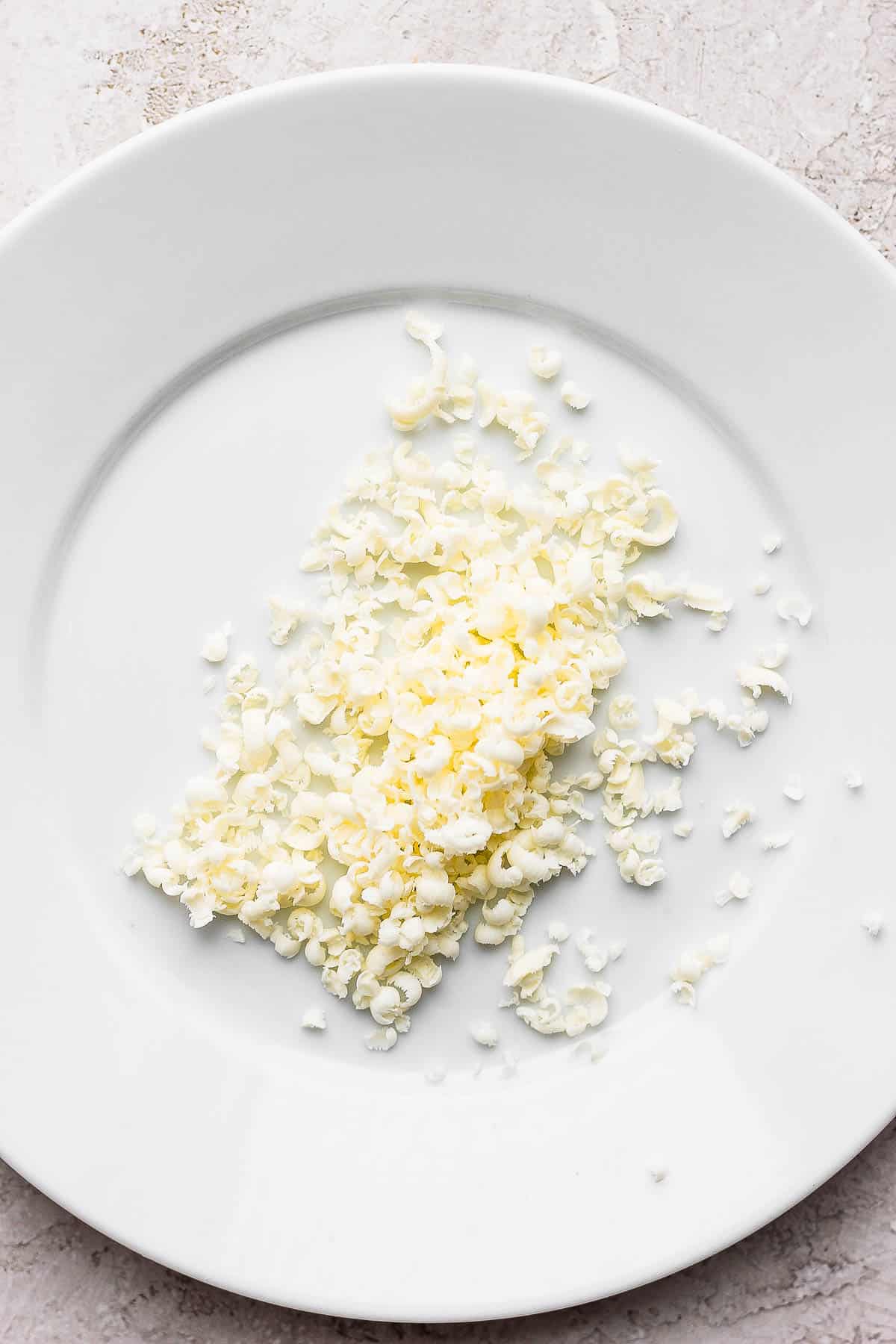 Grated frozen butter on a plate.
