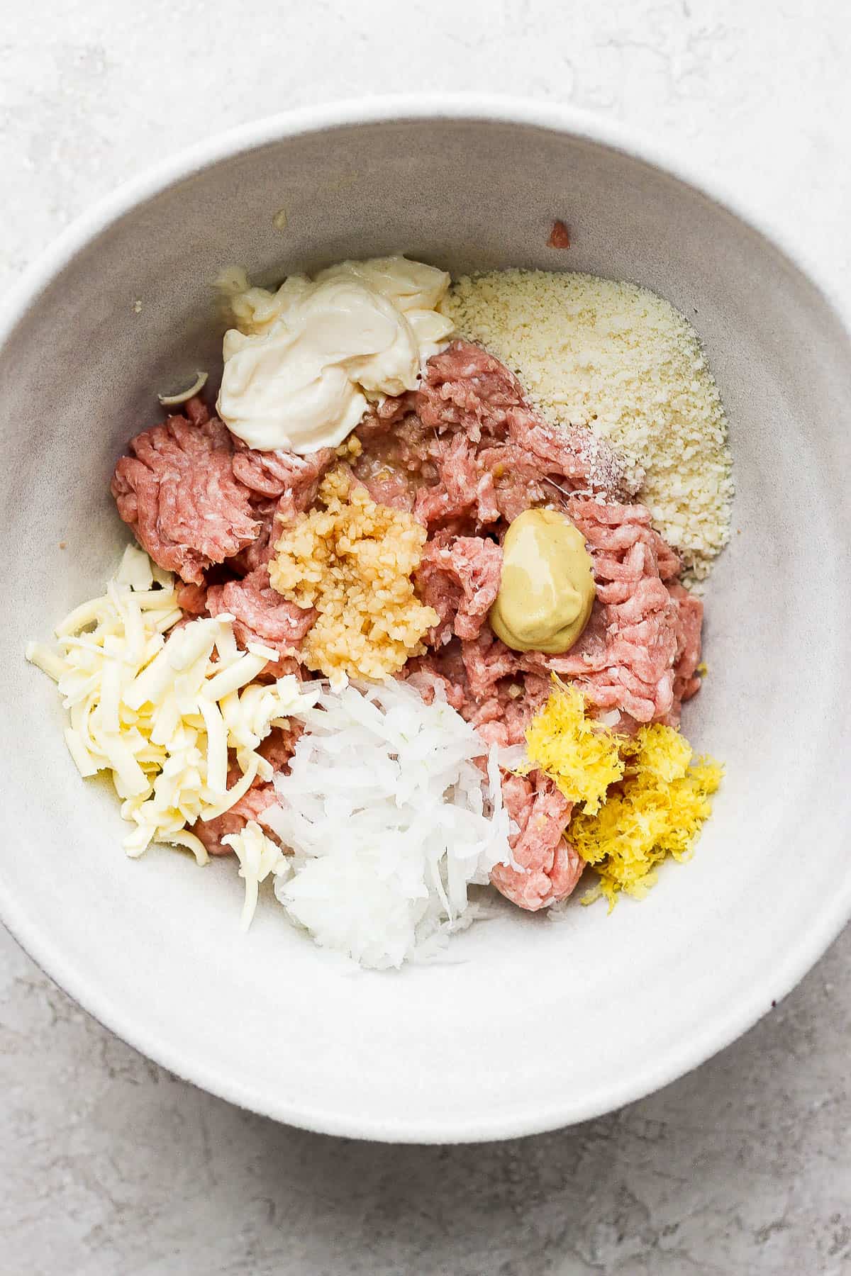 Ingredients for turkey avocado burgers in a bowl.