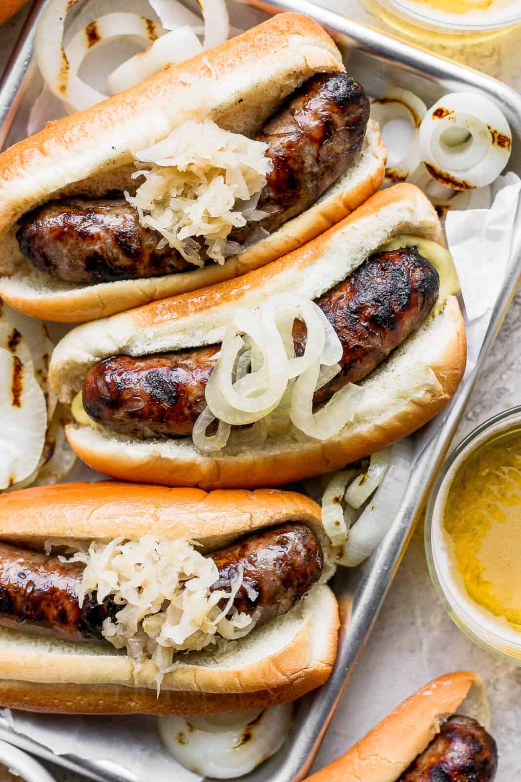 A tray of grilled beer brats.