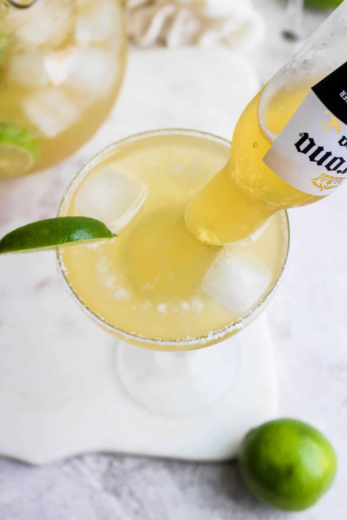 A corona sticking out of a beer margarita.