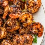 Close up of a plate of blackened shrimp.