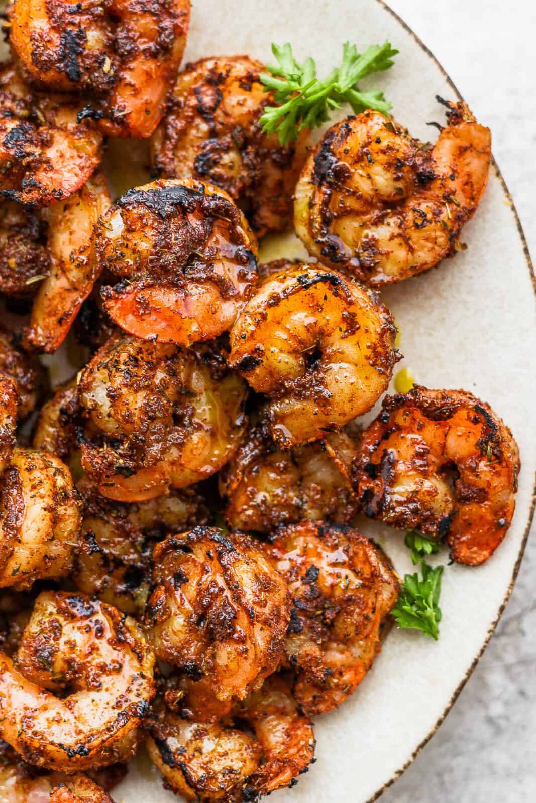 A plate of grilled blackened shrimp.