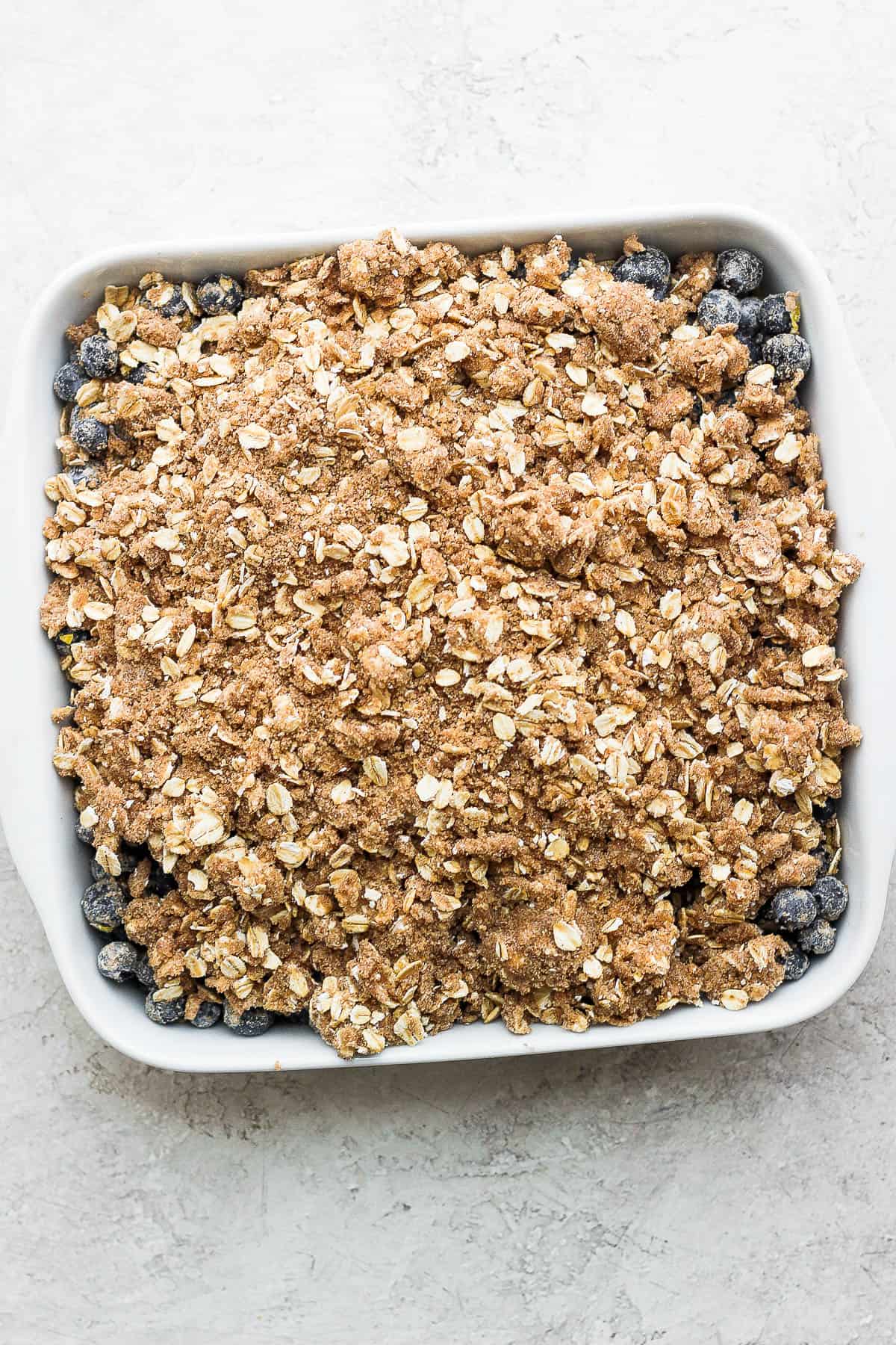 The crisp topping on top of the blueberry mixture before baking.