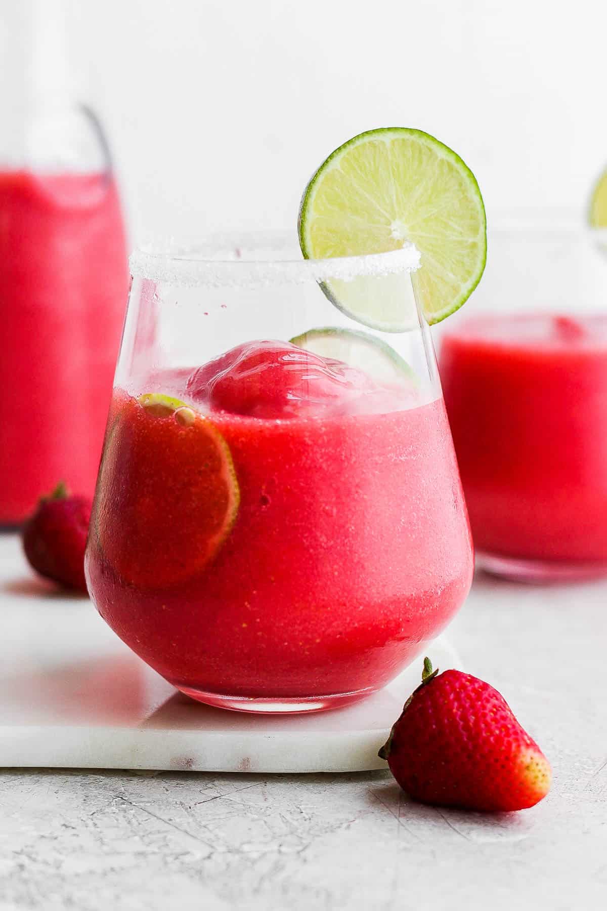 A strawberry margarita in a cocktail glass.