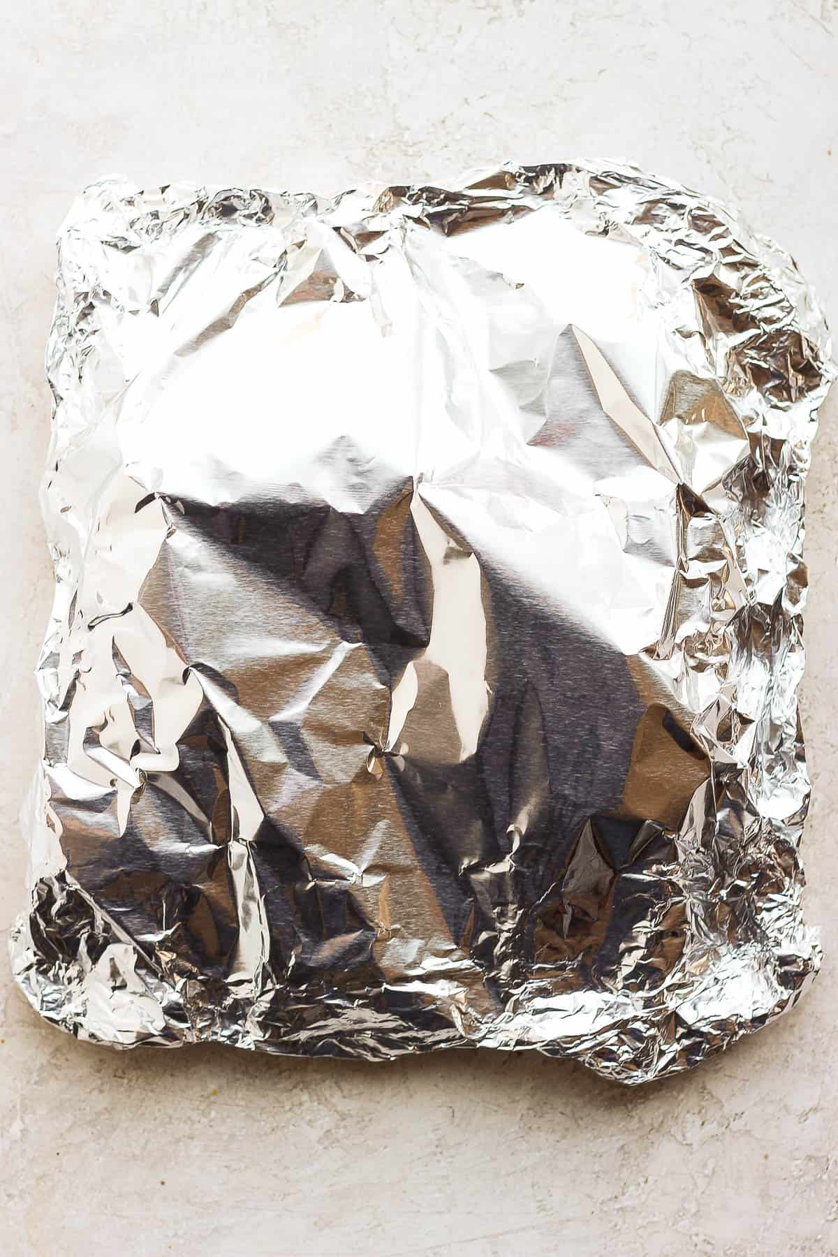 A foil packet containing four ears of corn. 