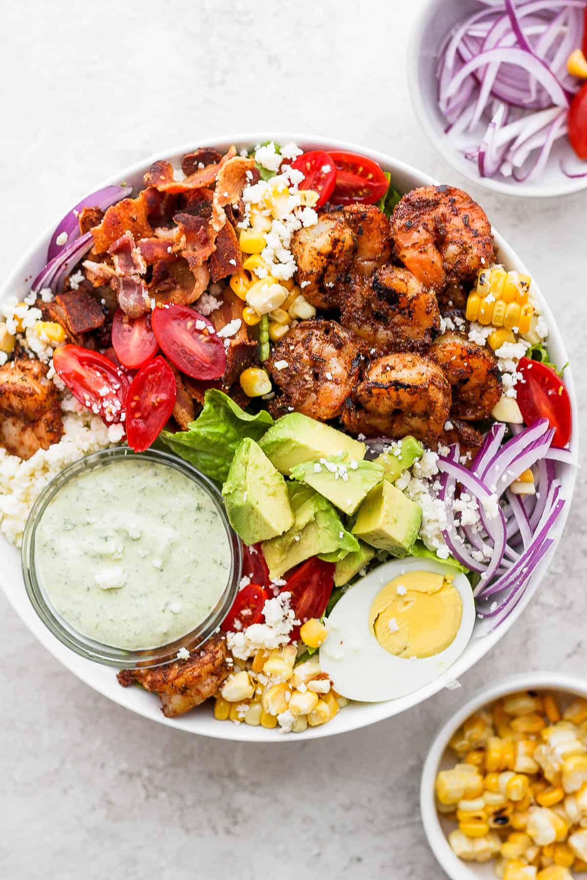 An ultimate grilled shrimp salad with all the toppings.
