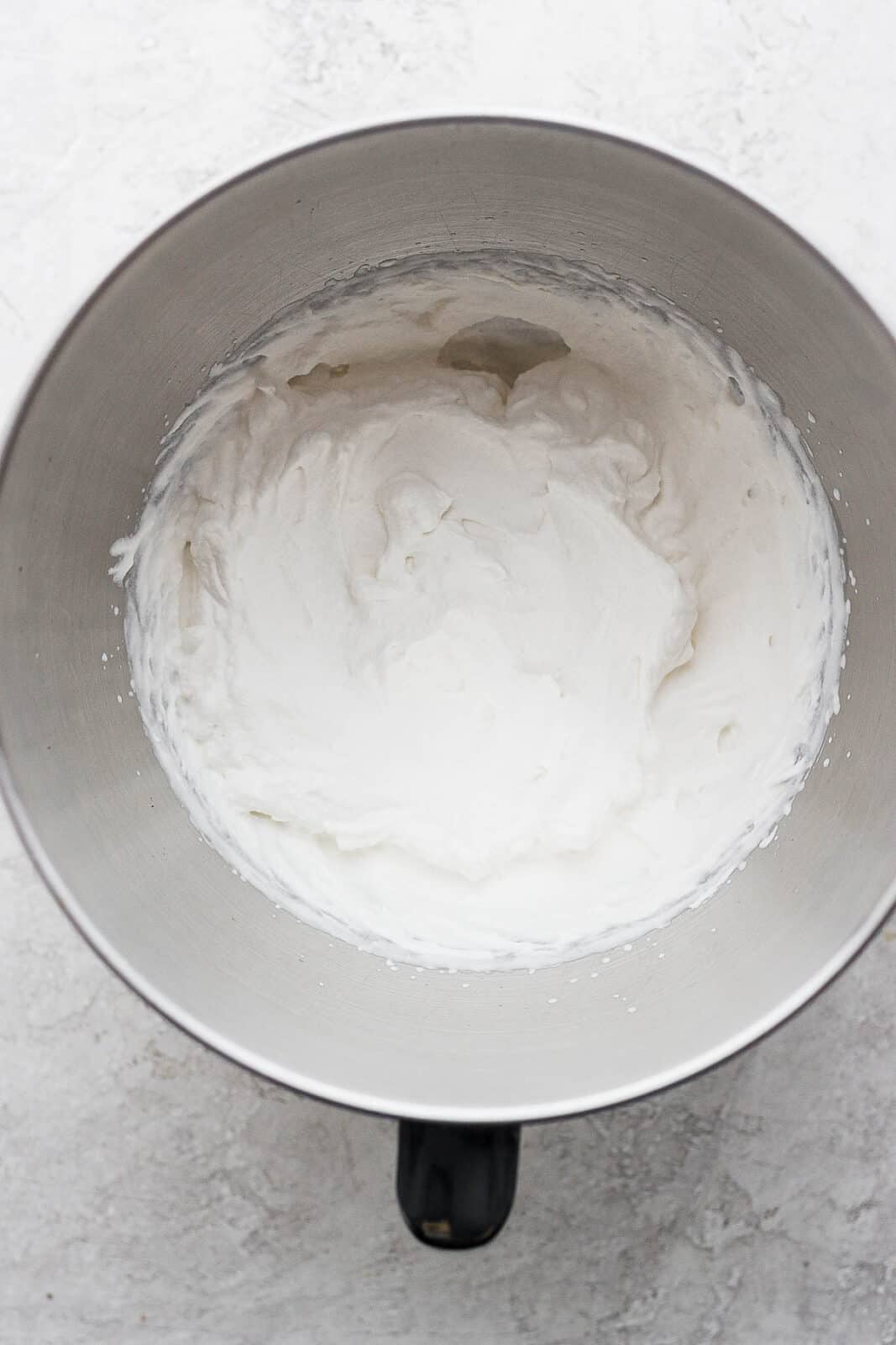 Whipped cream in a chilled mixing bowl.