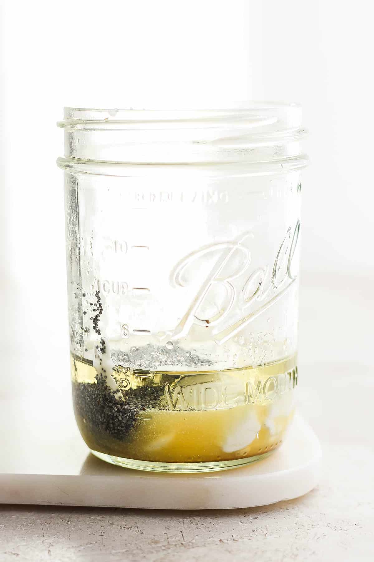 Ingredients for poppyseed salad dressing in a mason jar.