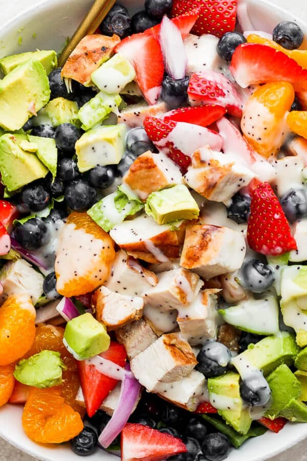Bowl of strawberry chicken salad with poppyseed dressing.