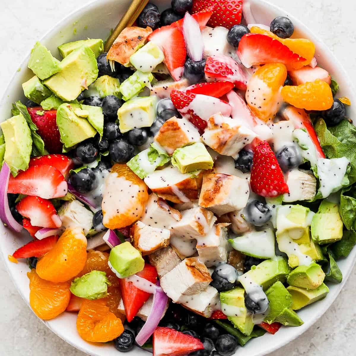 Bowl of strawberry chicken salad with poppyseed dressing.