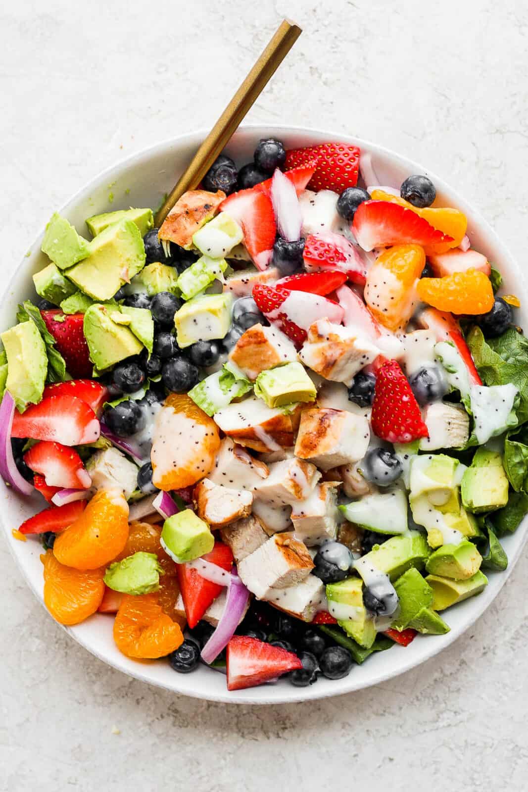 An easy strawberry chicken salad with dressing on top.