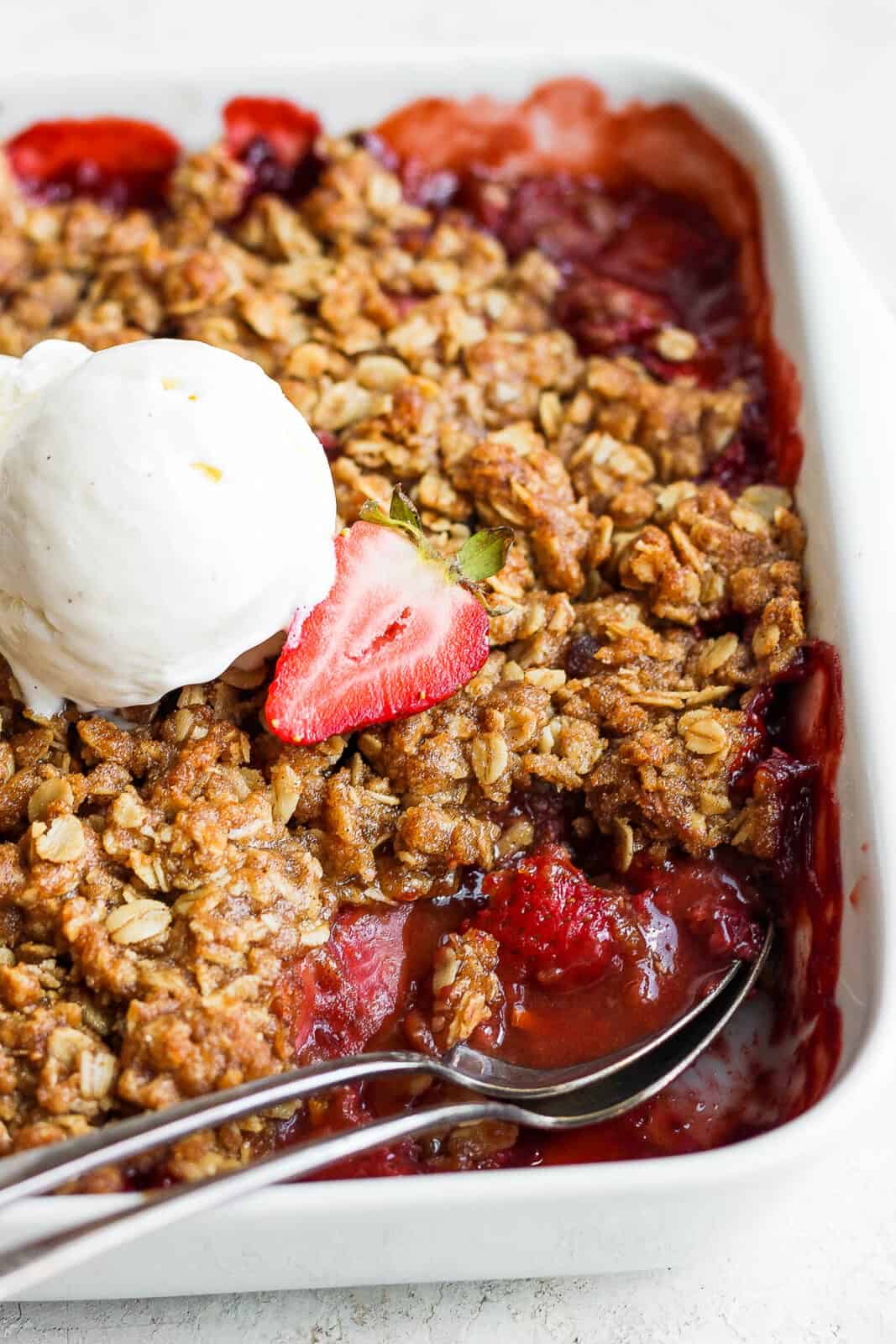 Strawberry crisp with 2 spoons.