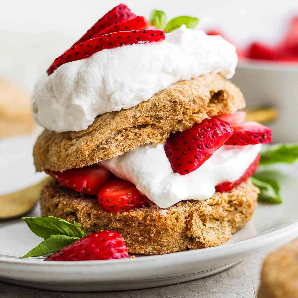 Healthy Strawberry Shortcake on a plate with basil garnish.