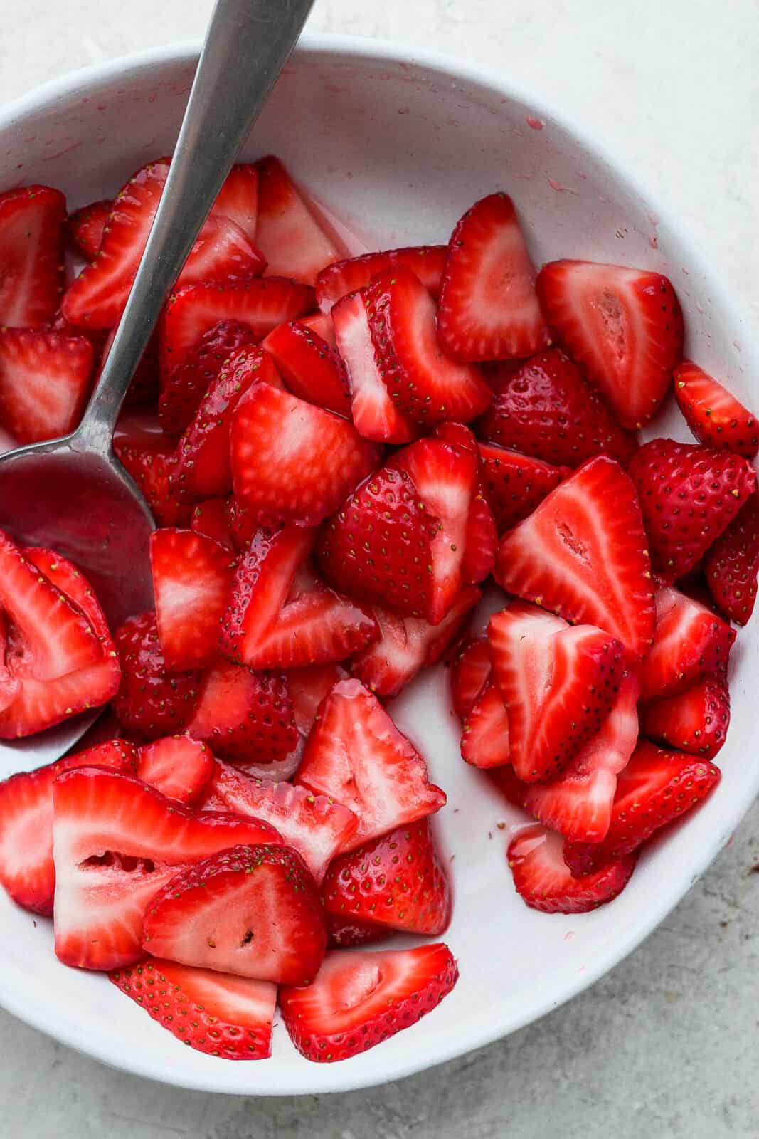 Macerated strawberries in a dish.