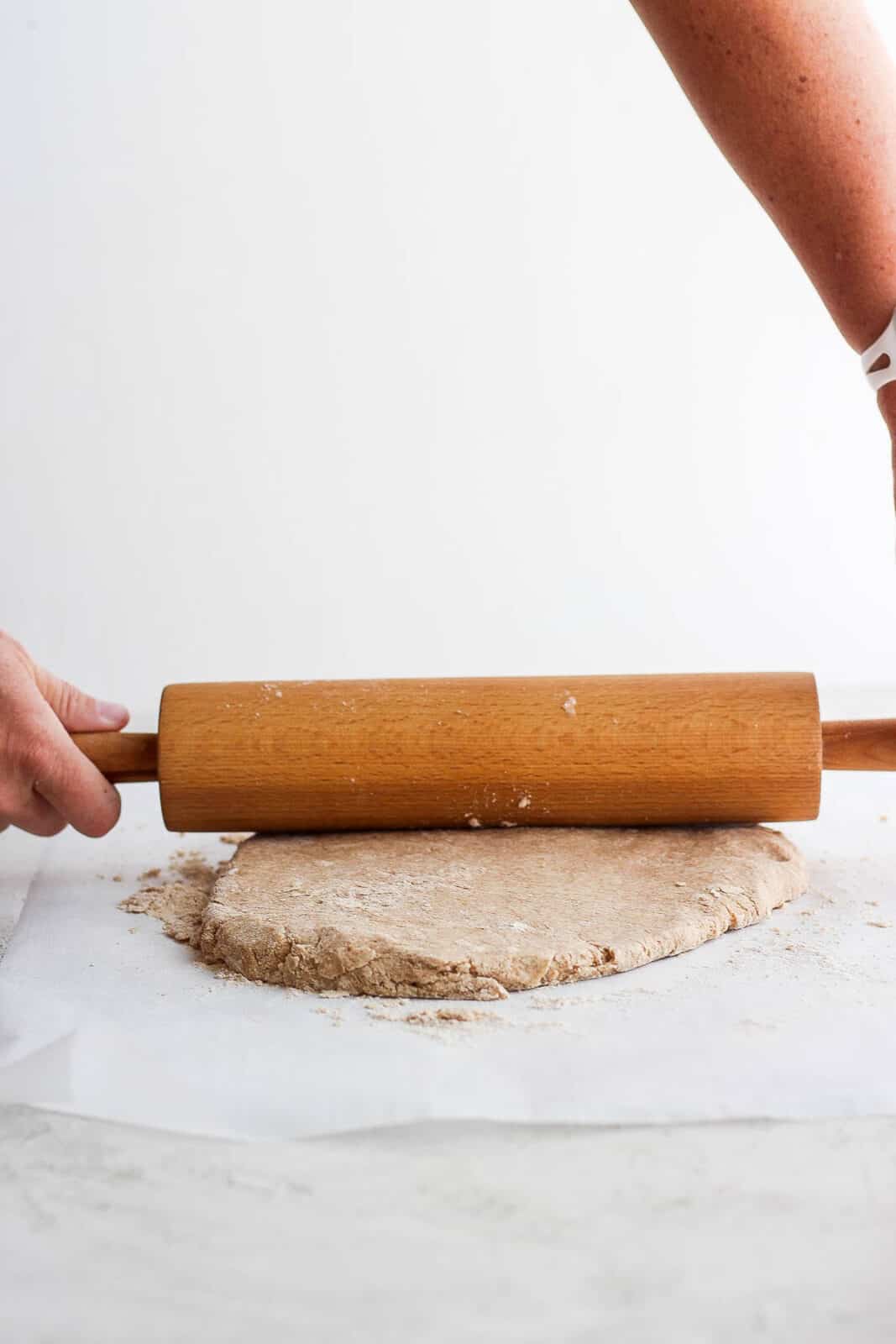 Shortcake dough being rolled out with a rolling pin.
