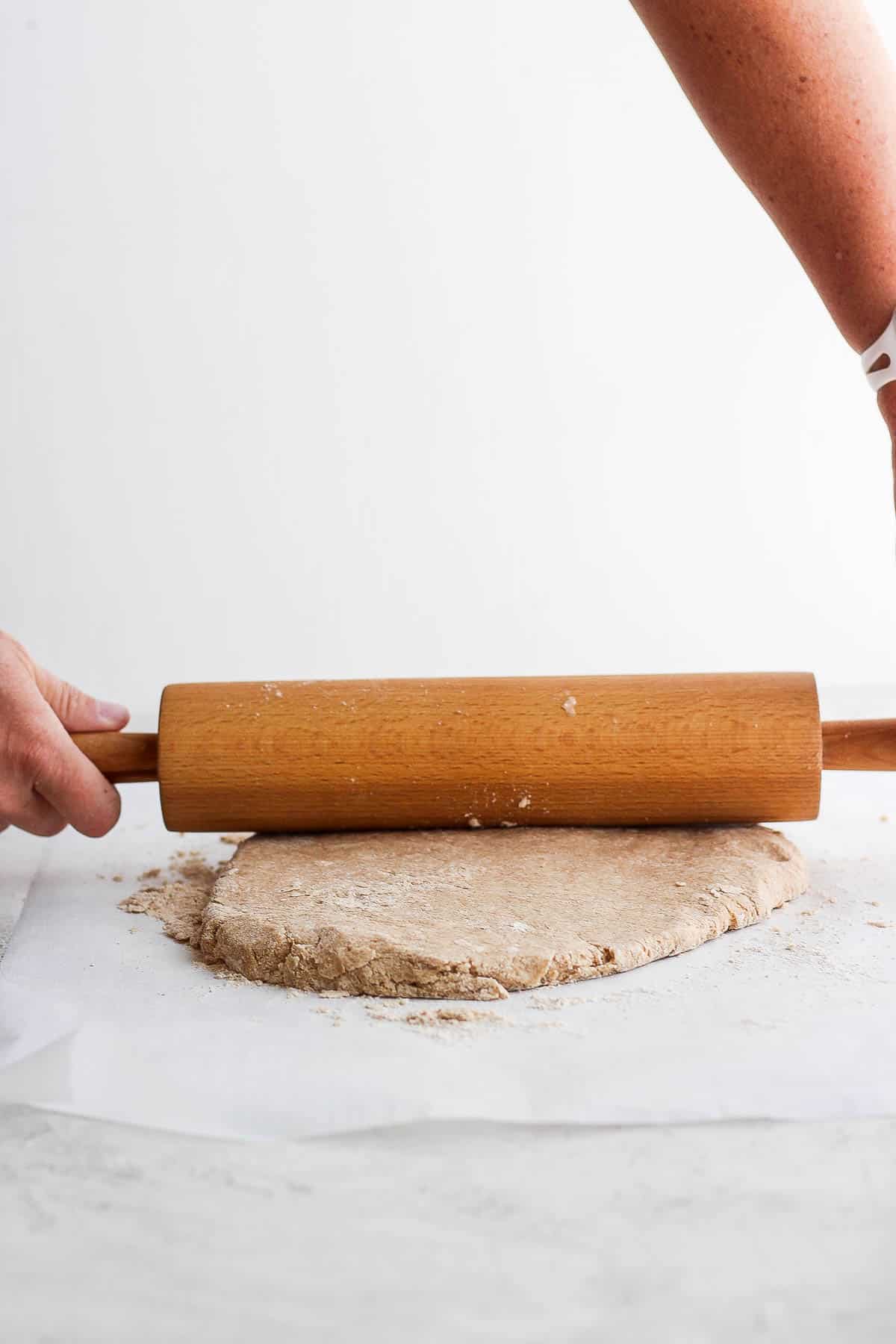 Shortcake dough being rolled out with a rolling pin.
