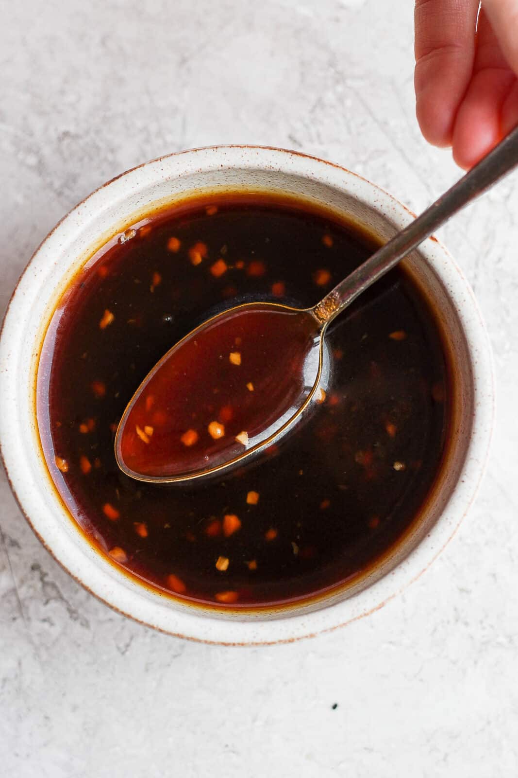 Homemade teriyaki sauce in a bowl with a spoon.