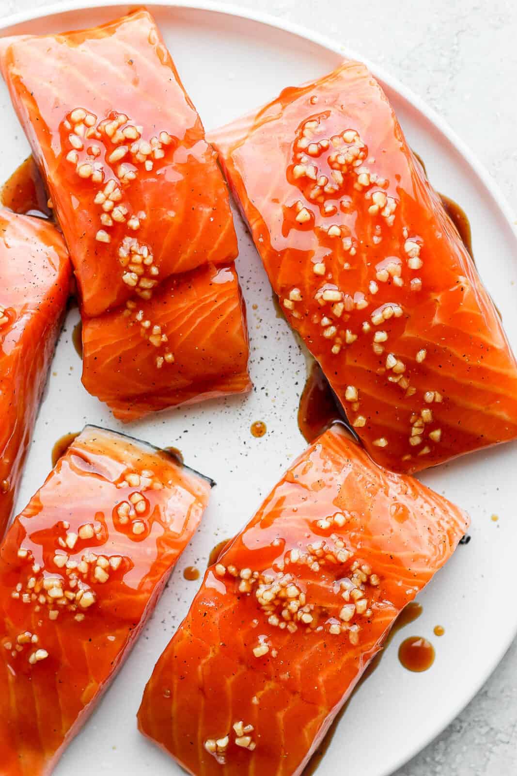 Fresh salmon fillets with teriyaki sauce on top.