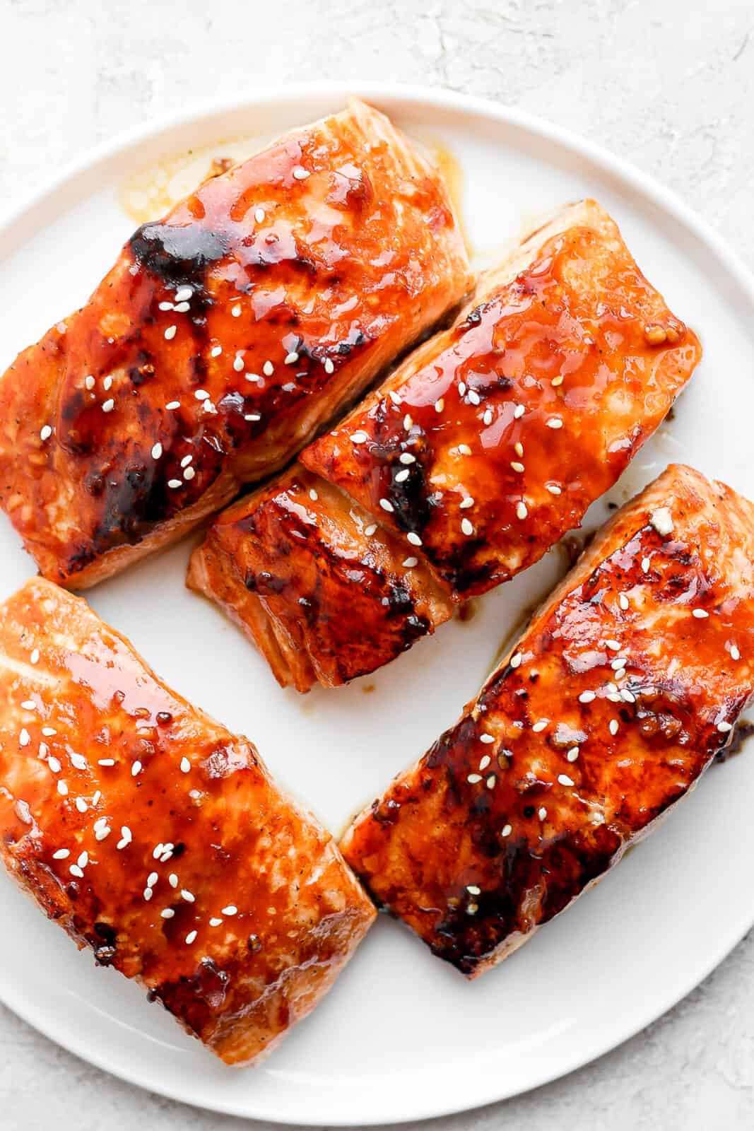 Teriyaki salmon fillets on a plate.