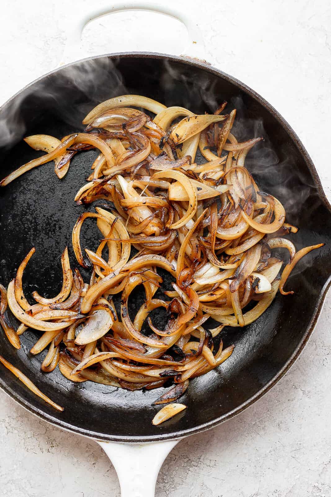 Caramelized whiskey onions in a cast iron skillet.
