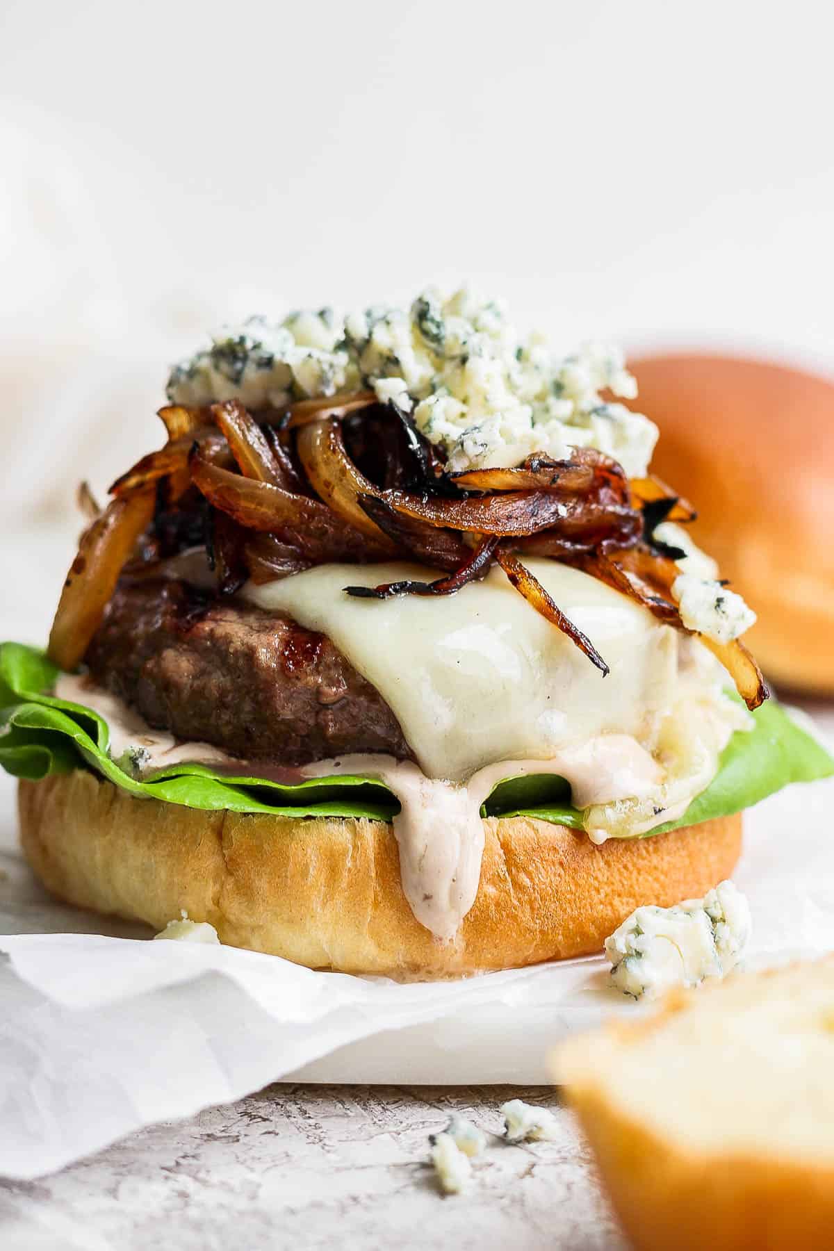 Bison burger on a bottom bun with all of the toppings.
