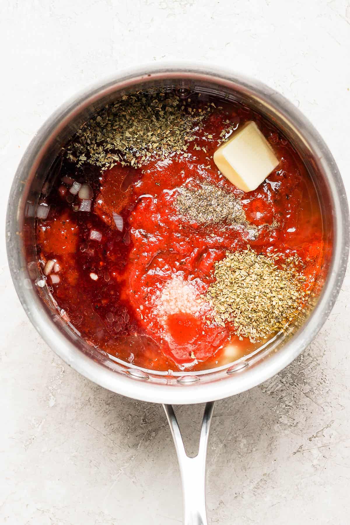 All the ingredients for an easy pasta sauce in a saucepan.