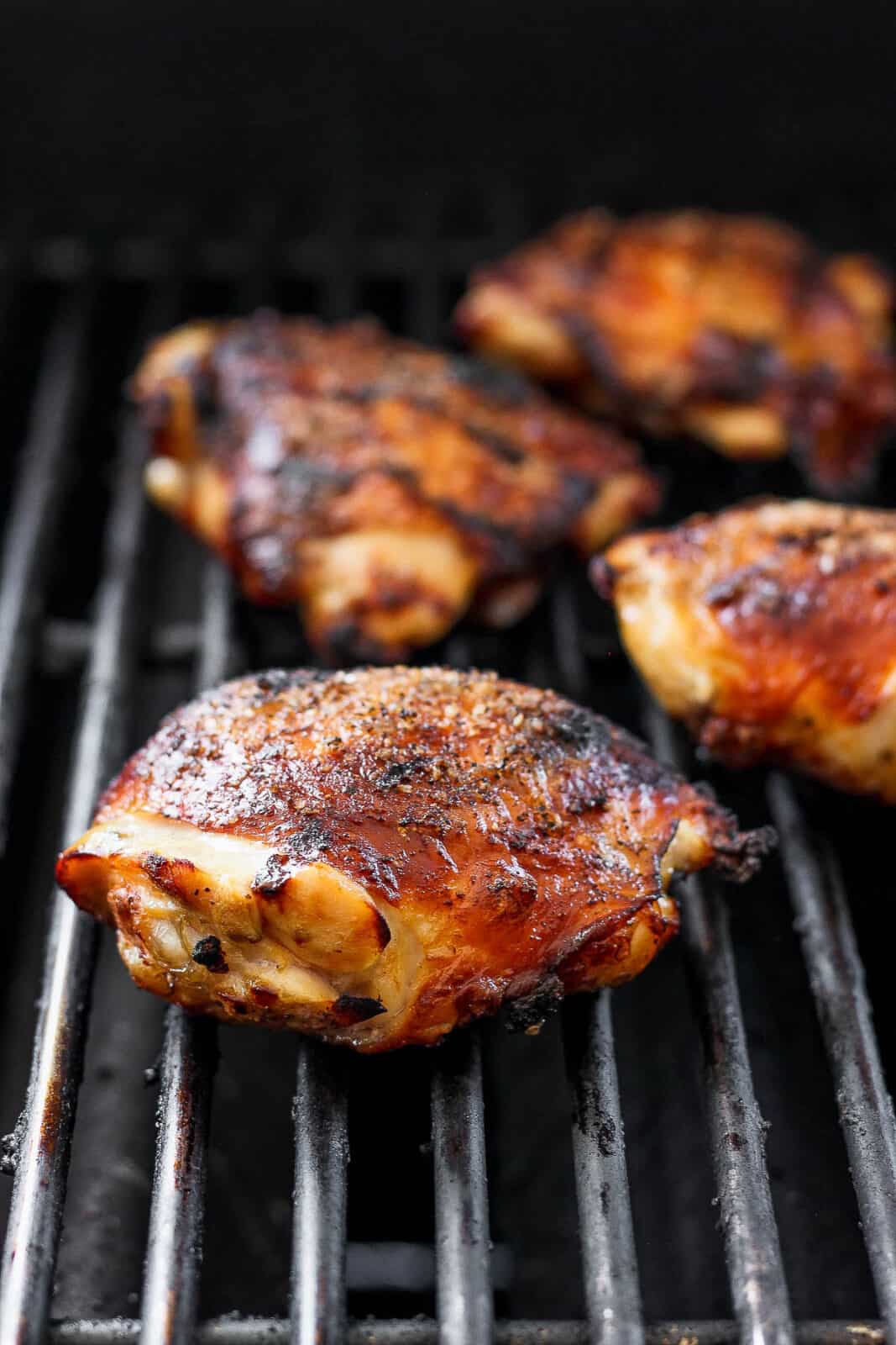 Chicken thighs on a grill.