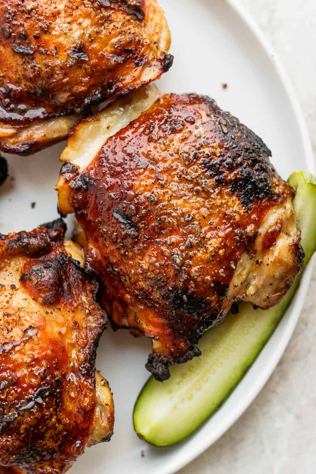 Grilled chicken thighs on a plate.