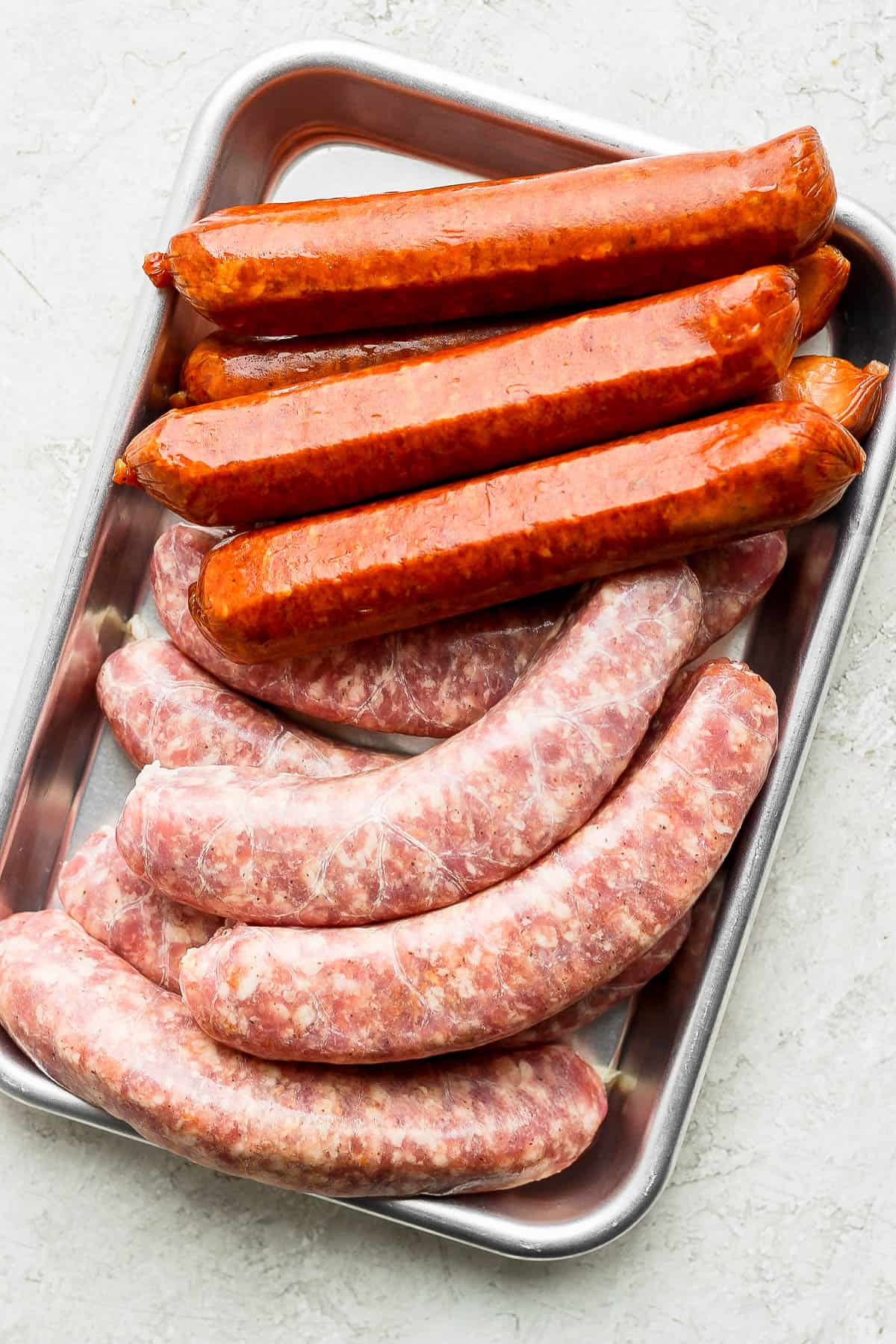 Plate of both raw and pre-cooked brats.